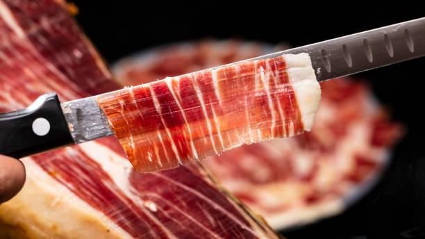 loncha de jamón sobre cuchillo alveolado